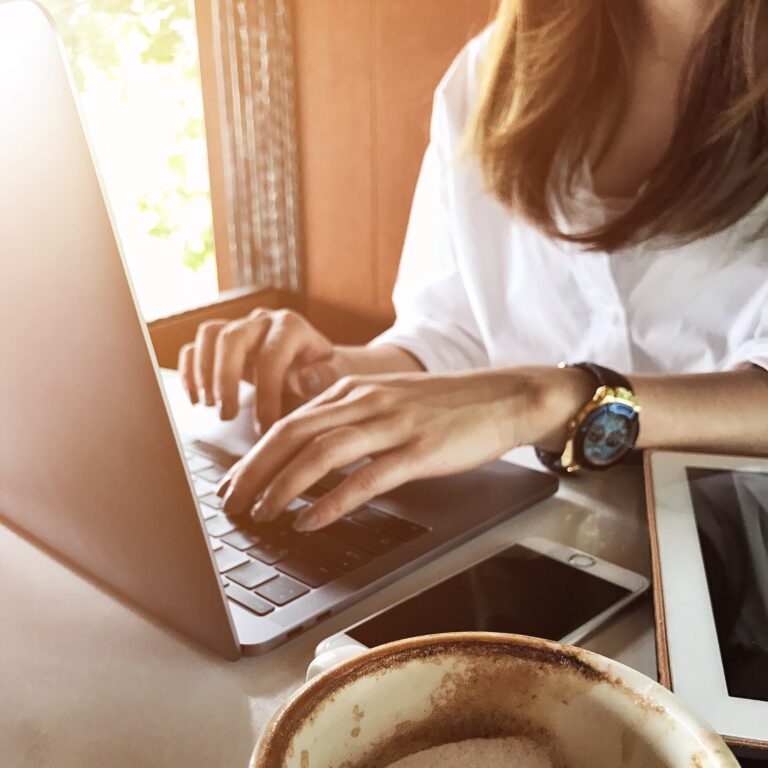 Women using laptop technology working in the cafe